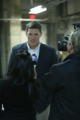 U.S. Army Sergeant Ben Simcox, is interviewed by a television news team prior to the start of the commencement ceremonies for Eastern Michigan university at the Convocation Center in Ypsilanti, on Sunday, April 29, 2012. For annarbor.com By: Joe Sharp